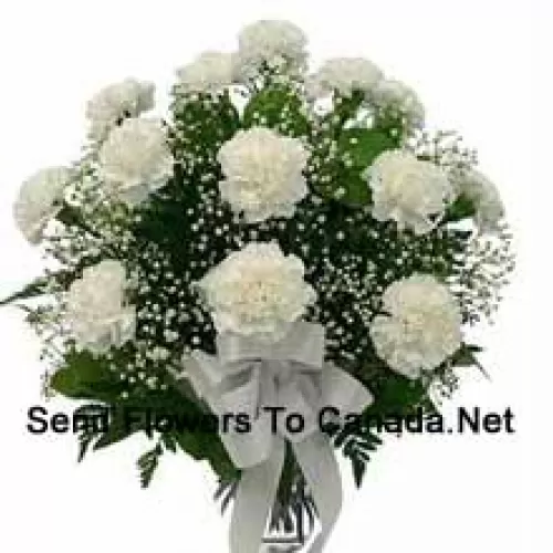 19 White Carnations With Seasonal Fillers In A Glass Vase