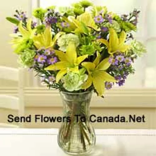 Yellow Lilies And Other Assorted Flowers Arranged Beautifully In A Glass Vase