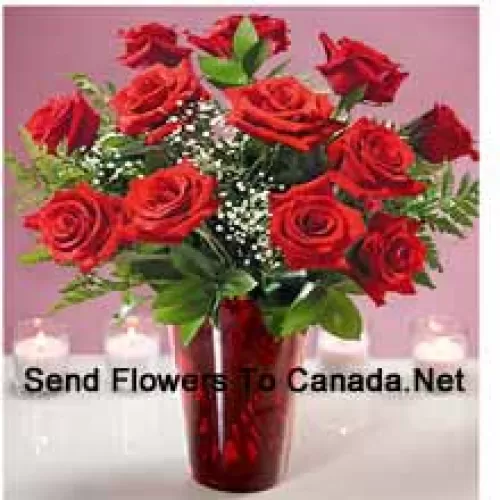 11 Red Roses With Some Ferns In A Glass Vase