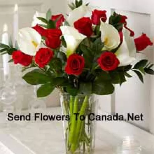 Red Roses And White Lilies With Some Ferns In A Glass Vase