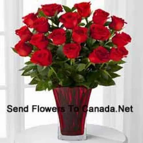 19 Red Roses With Seasonal Fillers In A Glass Vase Decorated With A Pink Bow